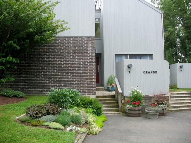 7 Orange Lane, Unit 7 Ridgefield, CT 06877 - Photo 1 of 1 a front view of a house with lots of green space