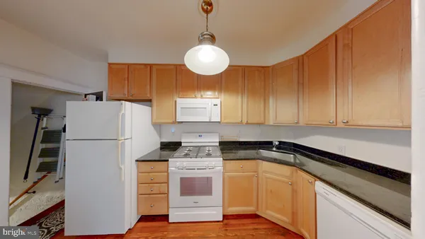 a kitchen with appliances cabinets and a counter top space