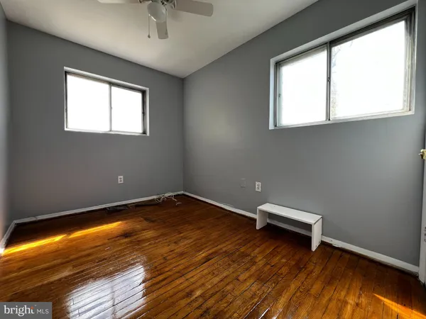 a view of room with window and wooden floor