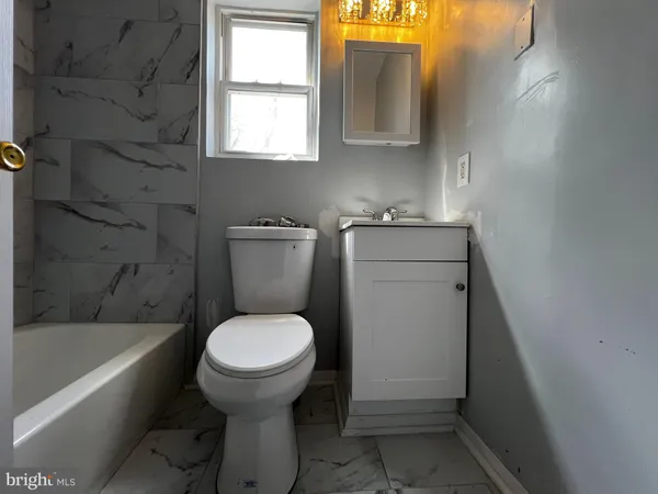 a bathroom with a sink toilet and bathtub