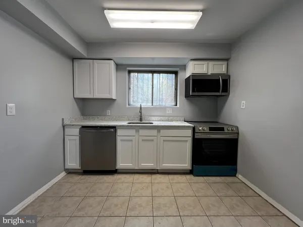 a kitchen with a sink and a stove top oven