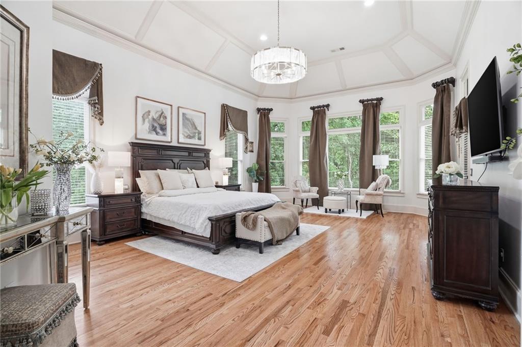 8340 Colonial Place Duluth, GA 30097 - Photo 22 of 74 a spacious bedroom with a bed and a flat screen tv