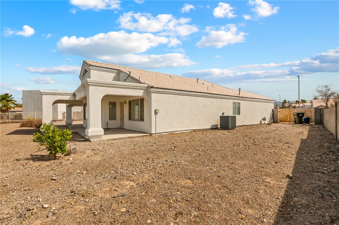 2853 Winchester Road Bullhead City, AZ 86442 - Photo 35 of 40 The property features an exterior with stucco siding and a tiled roof, alongside a covered patio area
