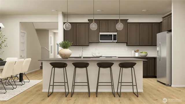 a kitchen with granite countertop a counter space chairs cabinets and stainless steel appliances