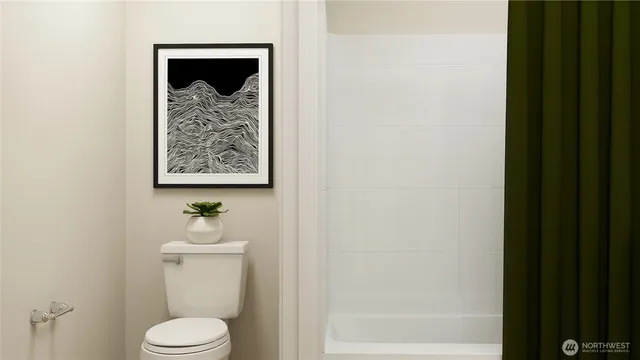 a white toilet sitting next to a bathroom sink