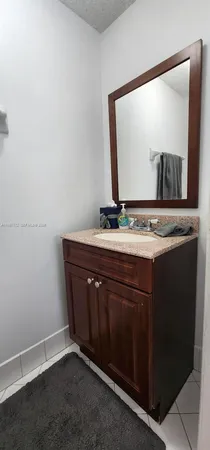 a white toilet sitting next to a bathroom sink