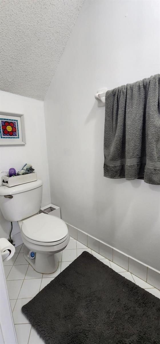 14133 Southwest 121st Place, Unit 9 Miami, FL 33186 - Photo 13 of 20 a white toilet sitting next to a bathroom sink