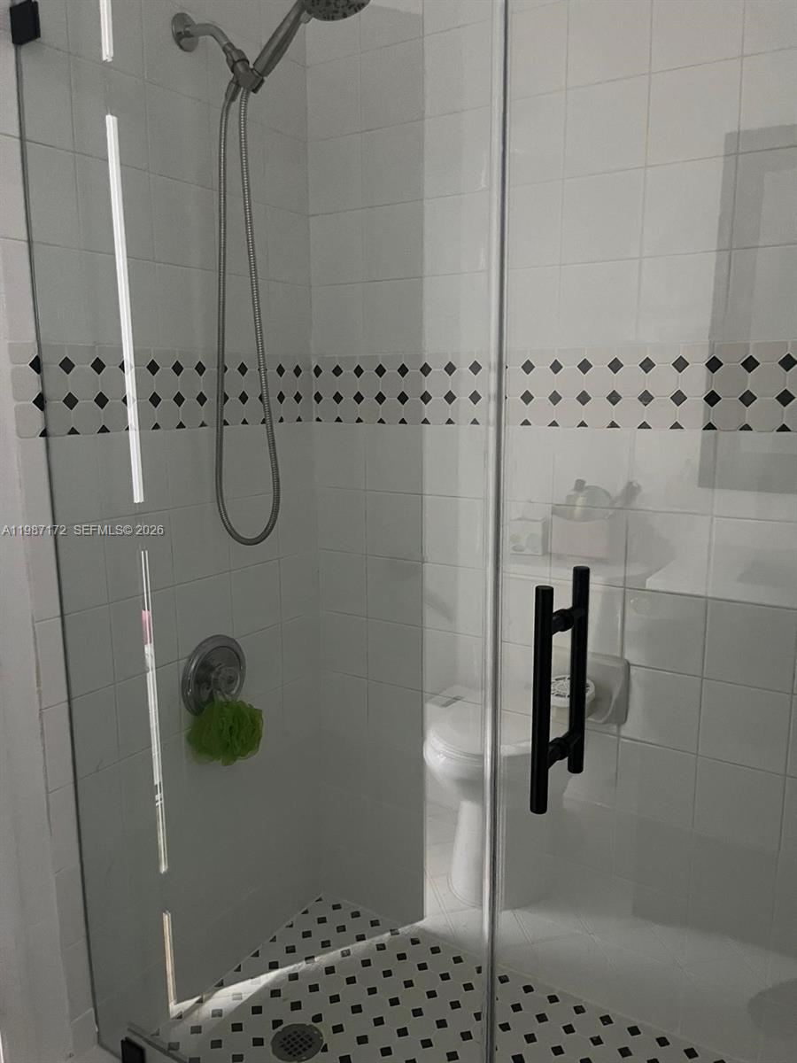 14133 Southwest 121st Place, Unit 9 Miami, FL 33186 - Photo 14 of 20 a bathroom with a shower