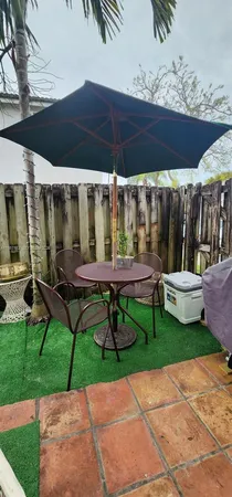 a view of a chairs and table in backyard