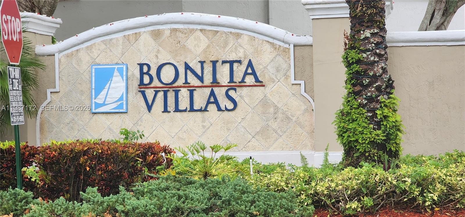 14133 Southwest 121st Place, Unit 9 Miami, FL 33186 - Photo 3 of 20 a sign that is on a brick wall
