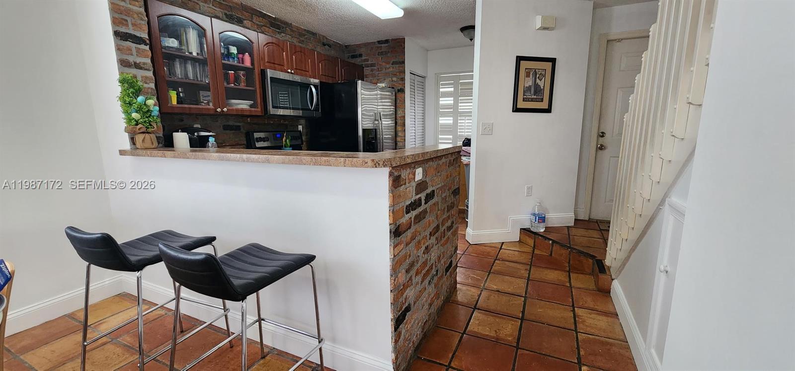 14133 Southwest 121st Place, Unit 9 Miami, FL 33186 - Photo 8 of 20 a view of living room kitchen and entryway