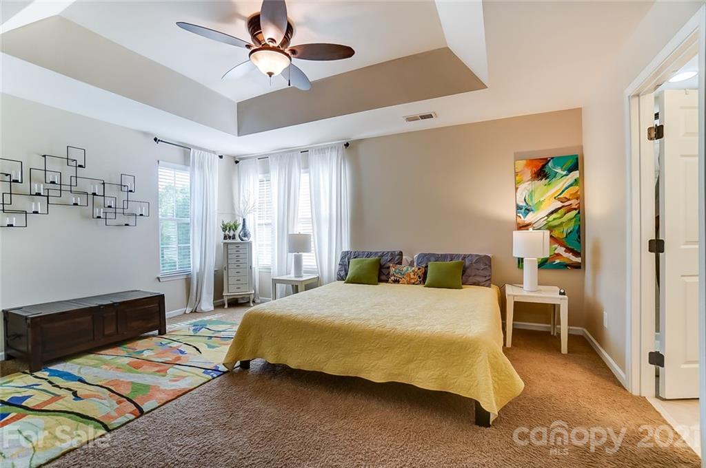725 Prospect Lane Fort Mill, SC 29708 - Photo 15 of 26 a bedroom with a bed and a chandelier