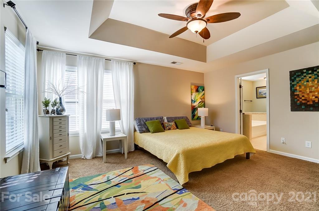725 Prospect Lane Fort Mill, SC 29708 - Photo 16 of 26 a bedroom with a bed and a chandelier