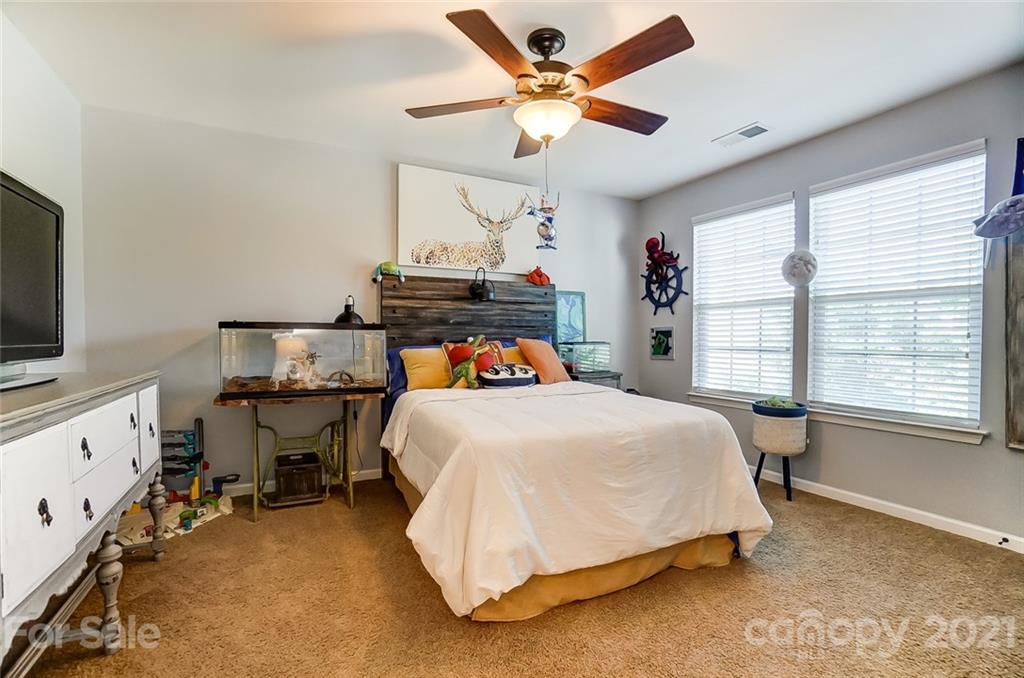 725 Prospect Lane Fort Mill, SC 29708 - Photo 19 of 26 a bed room with a bed and a chandelier