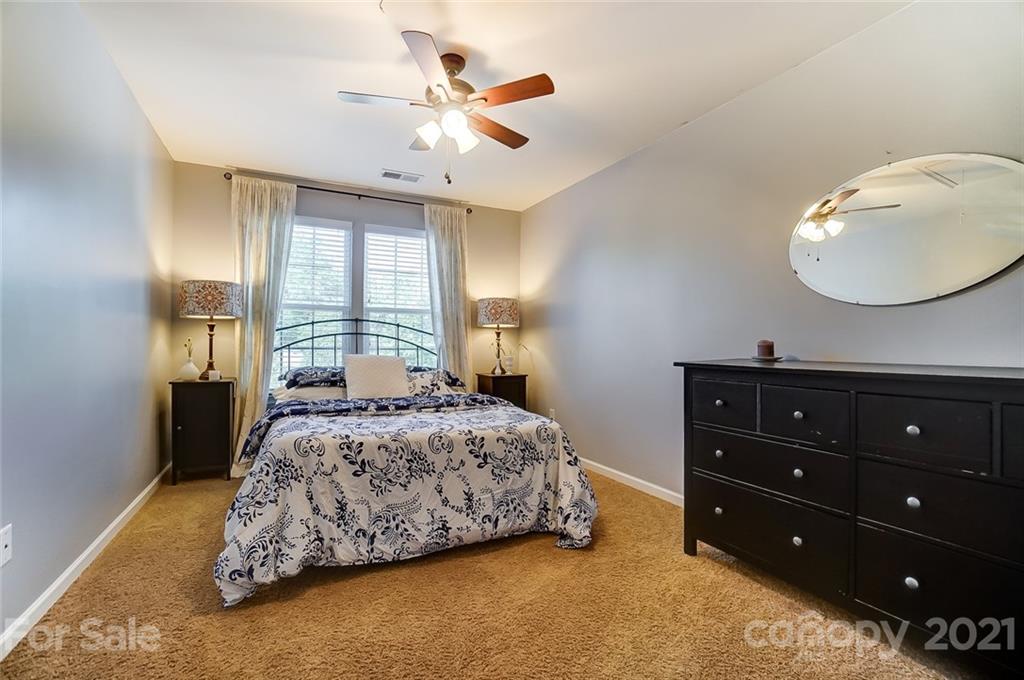 725 Prospect Lane Fort Mill, SC 29708 - Photo 21 of 26 a bedroom with a bed and a chandelier