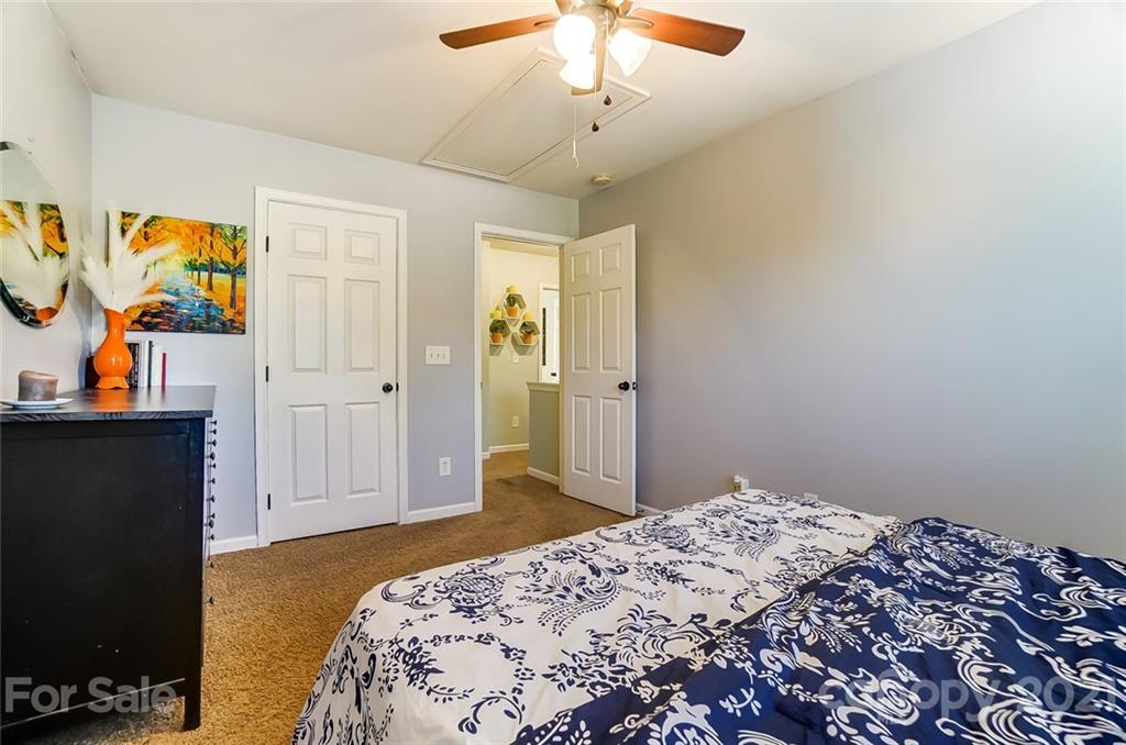 725 Prospect Lane Fort Mill, SC 29708 - Photo 22 of 26 a bedroom with a bed and a chandelier