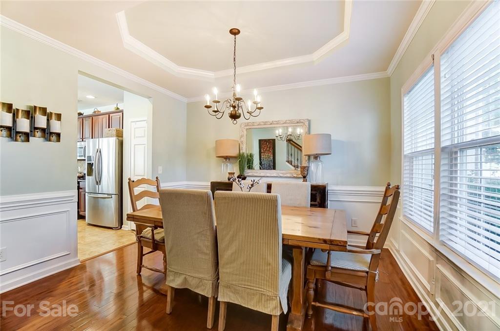 725 Prospect Lane Fort Mill, SC 29708 - Photo 4 of 26 a dining room with furniture a chandelier and wooden floor