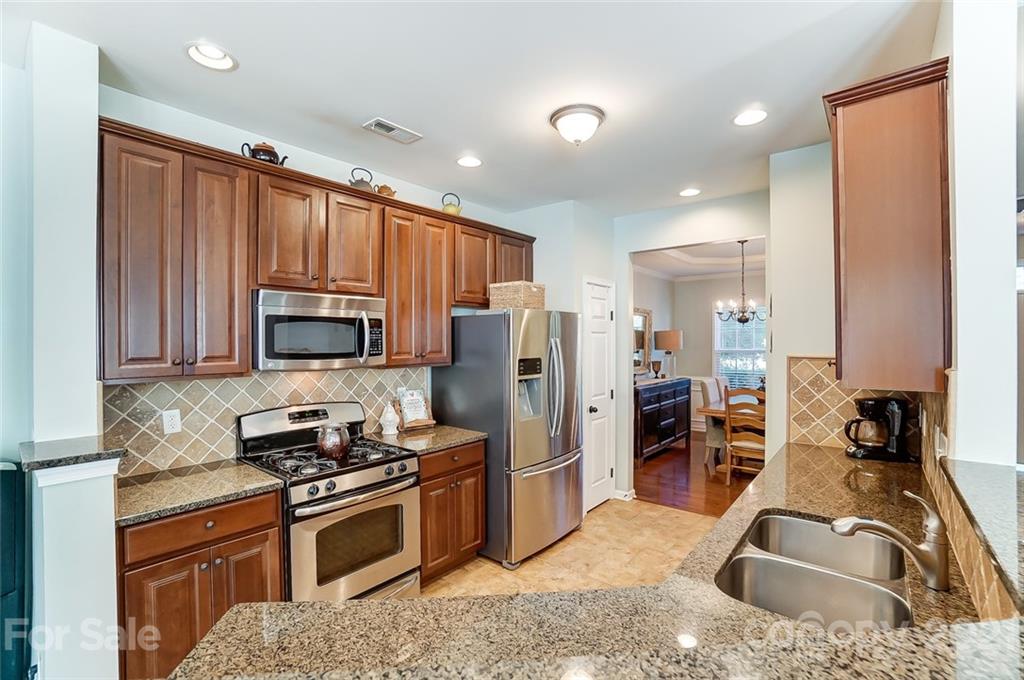 725 Prospect Lane Fort Mill, SC 29708 - Photo 5 of 26 a kitchen with stainless steel appliances granite countertop a refrigerator a stove top oven a sink and dishwasher