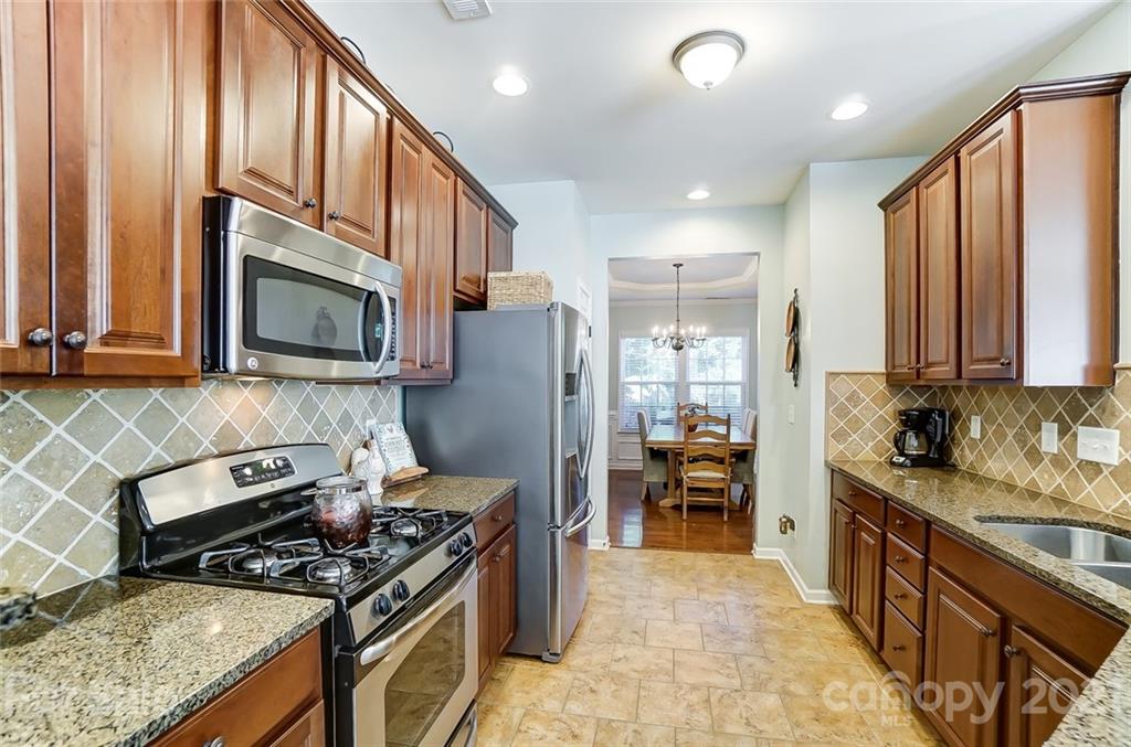 725 Prospect Lane Fort Mill, SC 29708 - Photo 6 of 26 a kitchen with stainless steel appliances granite countertop a stove top oven a sink dishwasher a refrigerator and a microwave