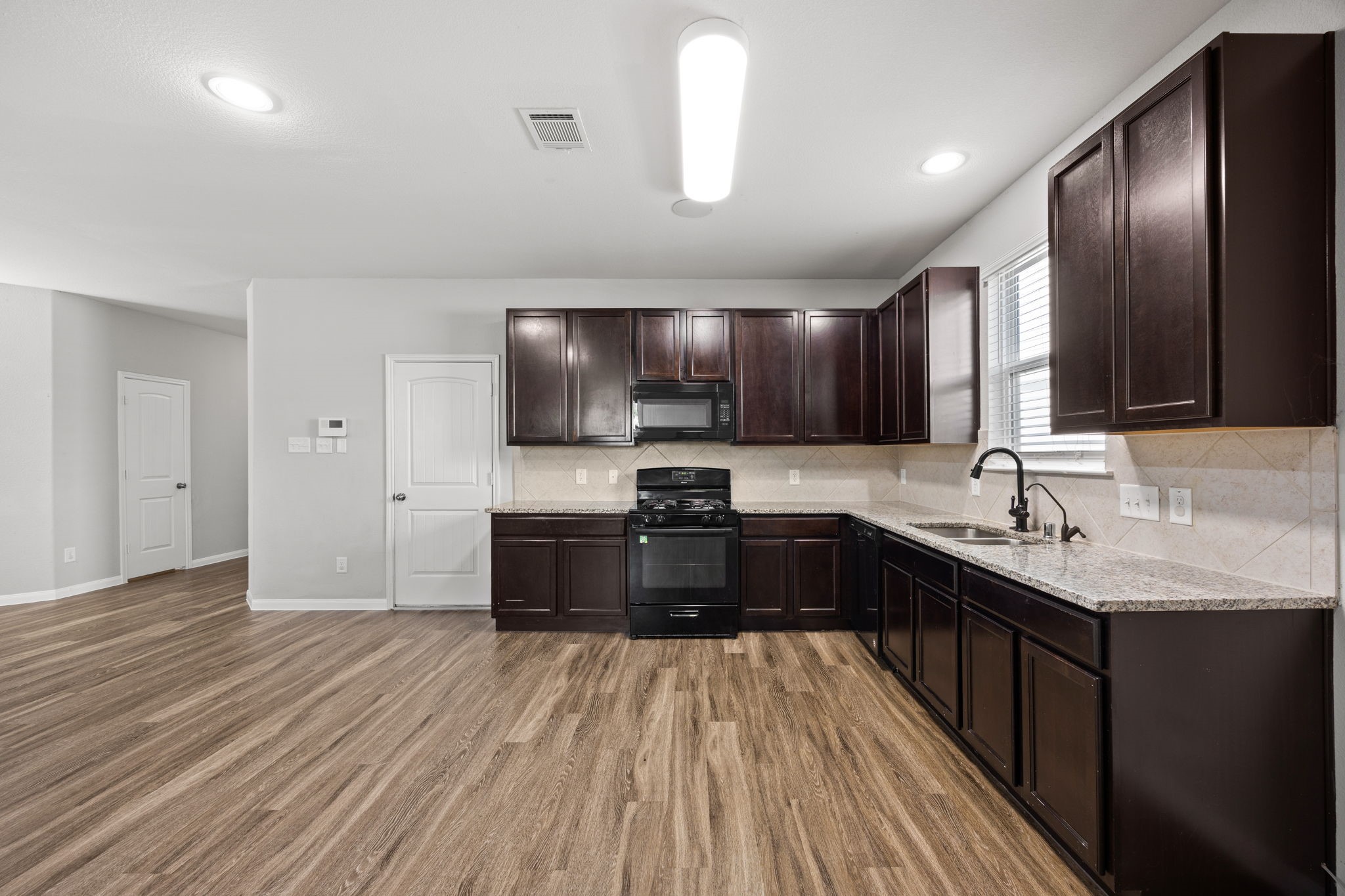18606 Lansdowne Stream Path Katy, TX 77449 - Photo 21 of 39 a kitchen with granite countertop a sink cabinets and stainless steel appliances