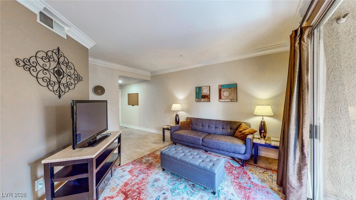 260 East Flamingo Road, Unit 229 Las Vegas, NV 89169 - Photo 31 of 31 Living room featuring ornamental molding and baseboards