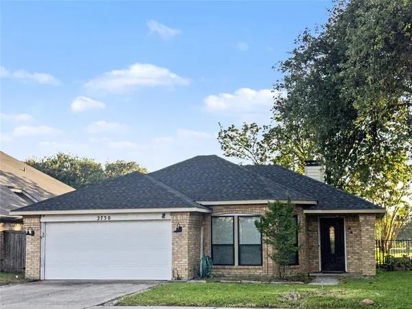 a front view of a house with a garden and yard