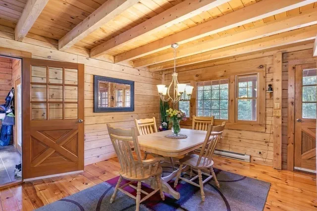 a view of a dining room with furniture wooden floor and chandelier