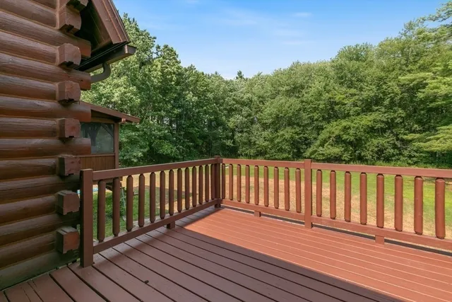 a balcony with wooden floor and fence