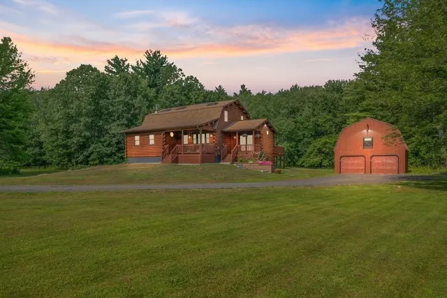a front view of a house with a garden and deck