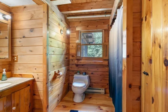 a living room with furniture a flat screen tv and a floor to ceiling window
