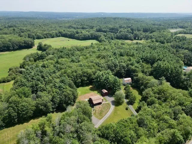 an aerial view of a house with yard
