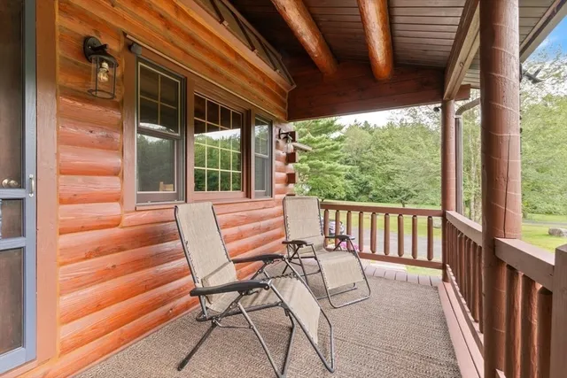 a view of a two chairs in the balcony