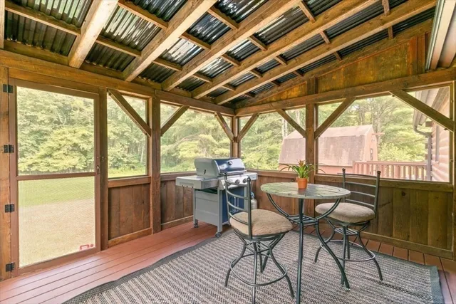 a outdoor dining space with furniture and wooden floor