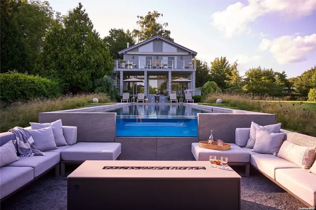 a view of a patio with couches chairs and a yard
