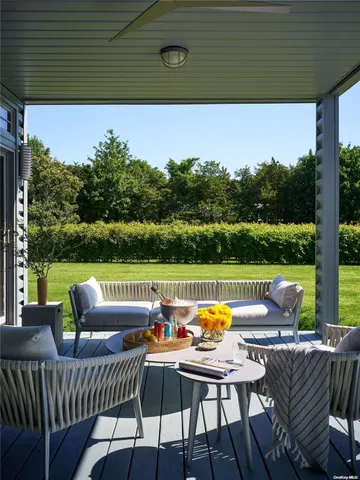 a view of a chairs and table in patio with a yard