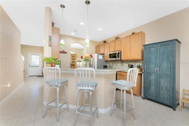 a living room with patio furniture and a potted plant