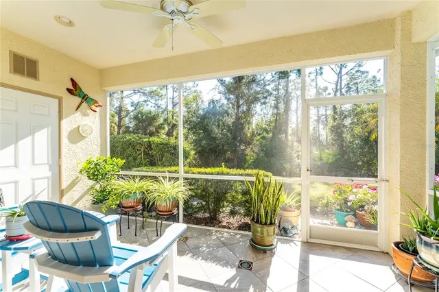 a living room filled with furniture and a potted plant