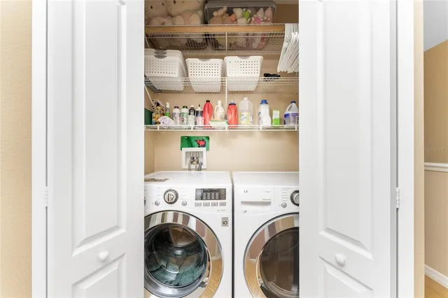 a view of a house with a yard and potted plants