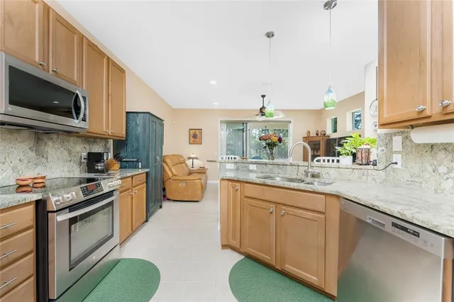 a kitchen with stainless steel appliances a stove microwave and sink