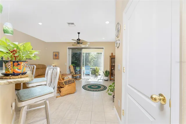 a living room with furniture a flat screen tv and a large window