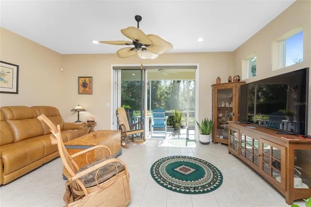 a living room with furniture and kitchen view
