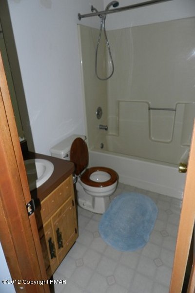 734 Decker Road Bushkill, PA 18324 - Photo 9 of 18 a bathroom with a granite countertop toilet a sink and a mirror