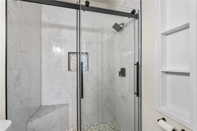 a patio with a table and chairs and potted plants