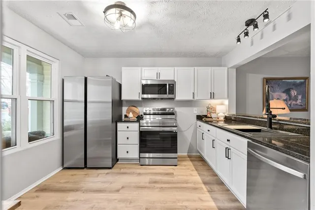 a view of a kitchen with a sink and living room