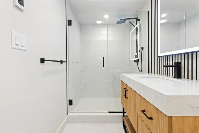 a bathroom with a bathtub and a shower