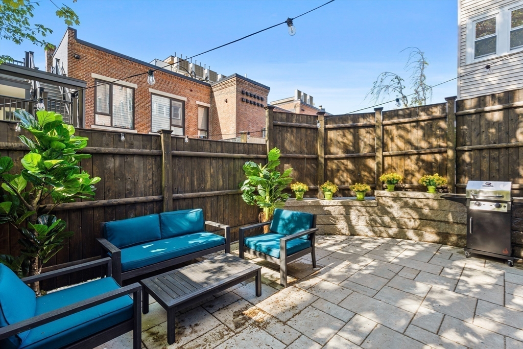 46 Lancaster Terrace, Unit 46 Brookline, MA 02446 - Photo 20 of 25 a view of a chairs and table in the backyard