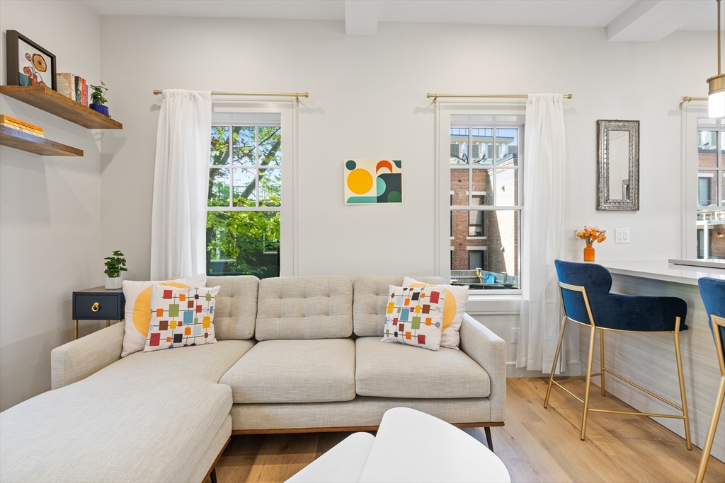 46 Lancaster Terrace, Unit 46 Brookline, MA 02446 - Photo 2 of 25 a living room with furniture and a window