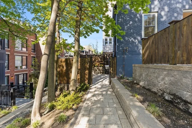 a view of a pathway of a house with a tree