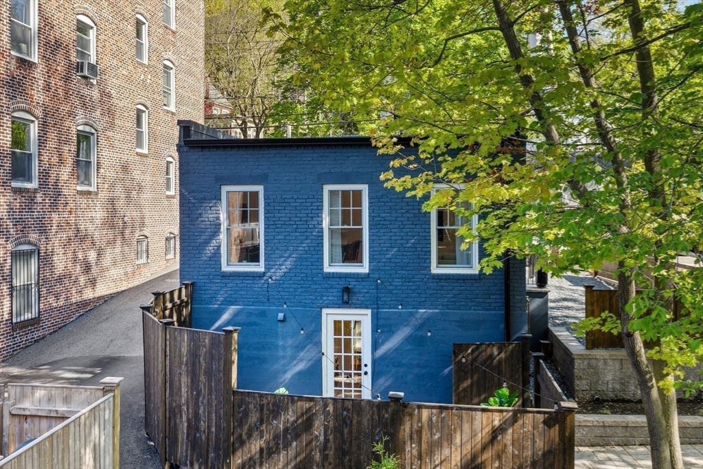 46 Lancaster Terrace, Unit 46 Brookline, MA 02446 - Photo 24 of 25 a brick house with plants in front of it