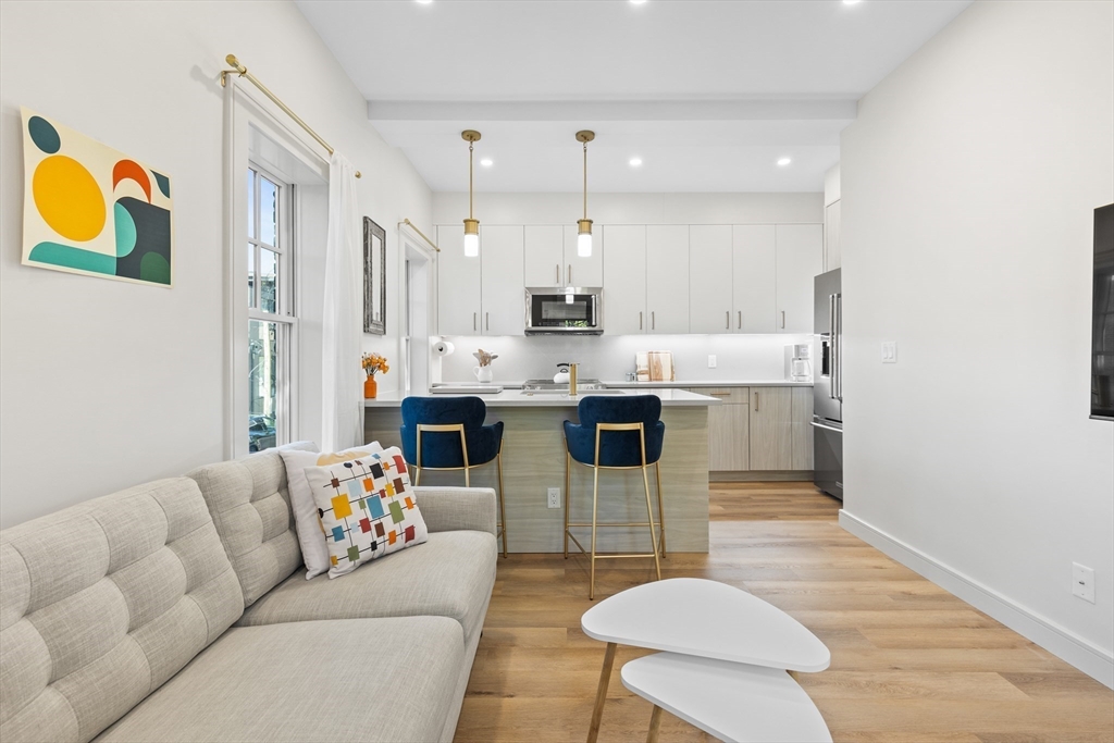 46 Lancaster Terrace, Unit 46 Brookline, MA 02446 - Photo 4 of 25 a living room with stainless steel appliances furniture and a kitchen view